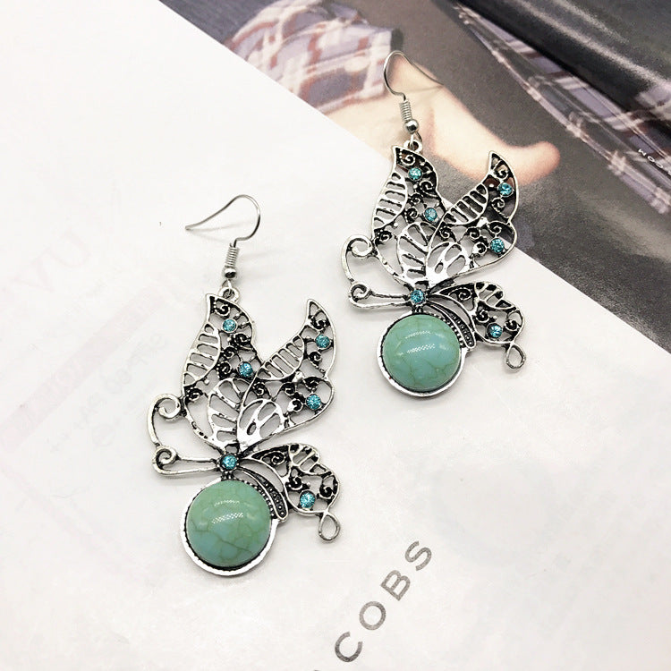 Flat lay display of necklace and earrings with turquoise details - image 6