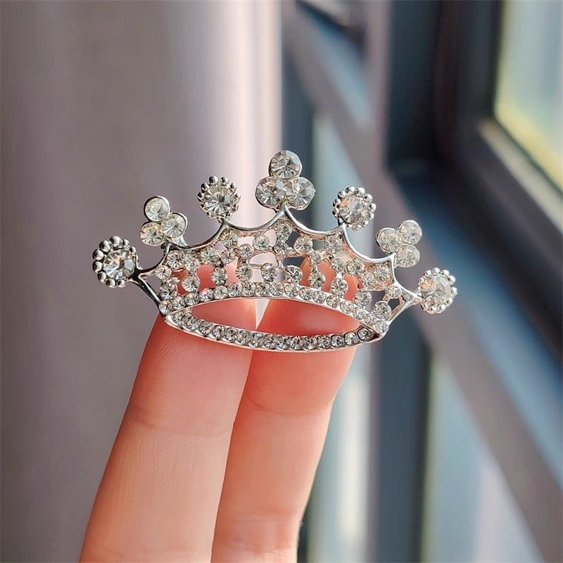 Couple's matching crown brooches
