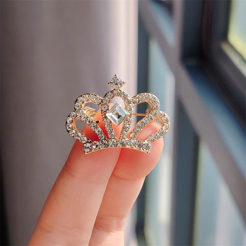 Gold crown brooch with rhinestones