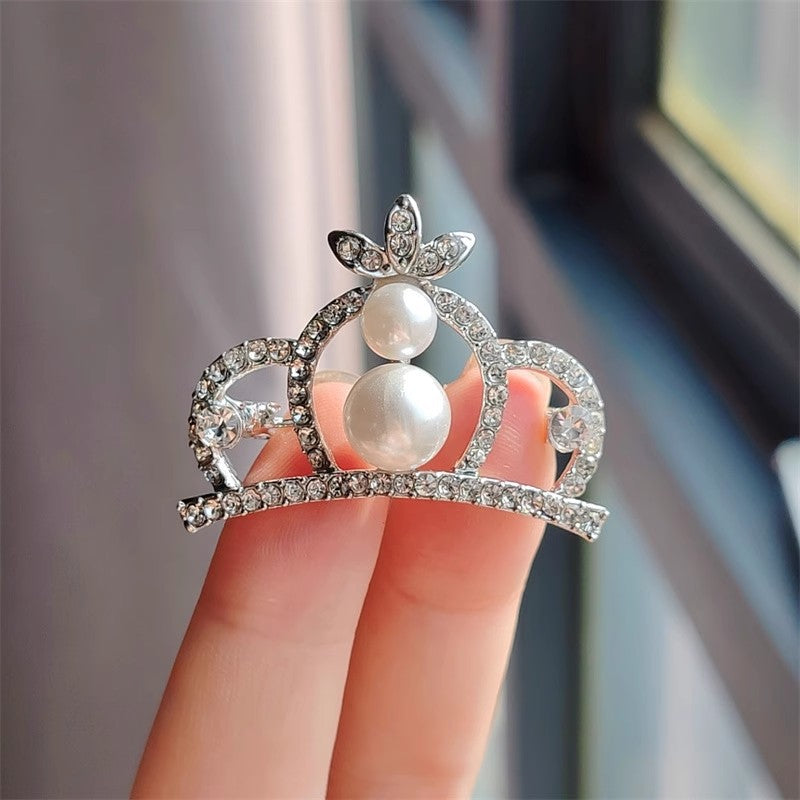 Detailed close-up of rhinestone crown pin