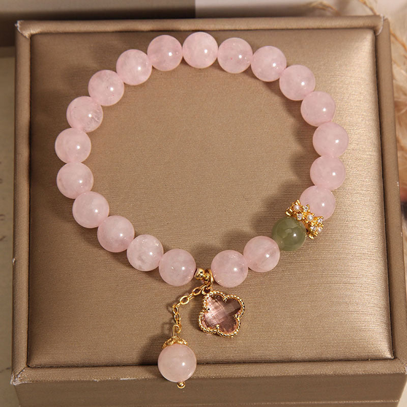 Wrist adorned with pink quartz bracelet