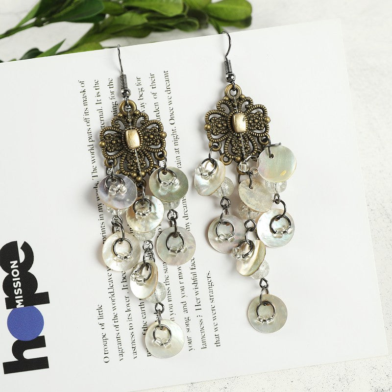 Casual outfit with shell earrings showcased