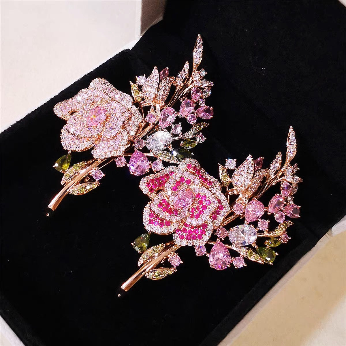 Purple rose brooch displayed on fabric