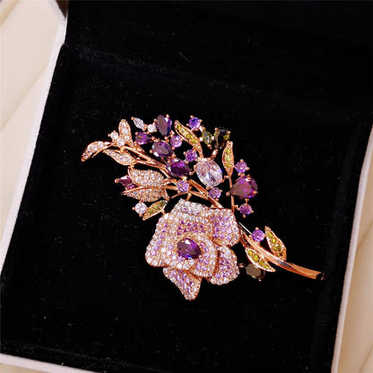 Purple rose brooch displayed on fabric
