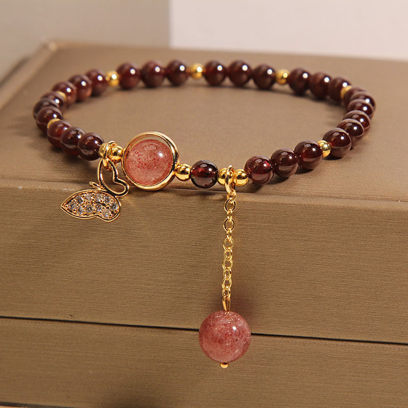 Garnet and butterfly bracelet charm close-up