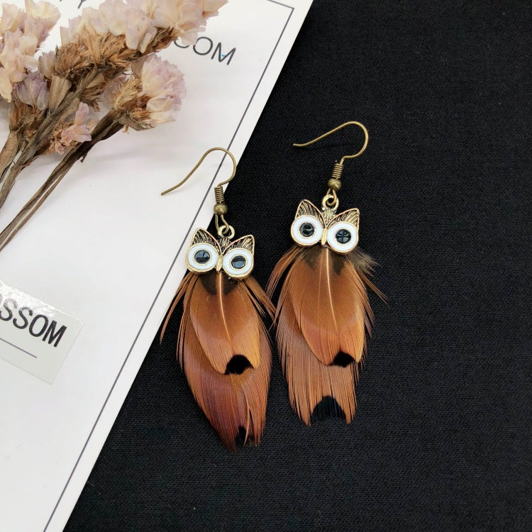 Peacock feather earrings displayed on a model