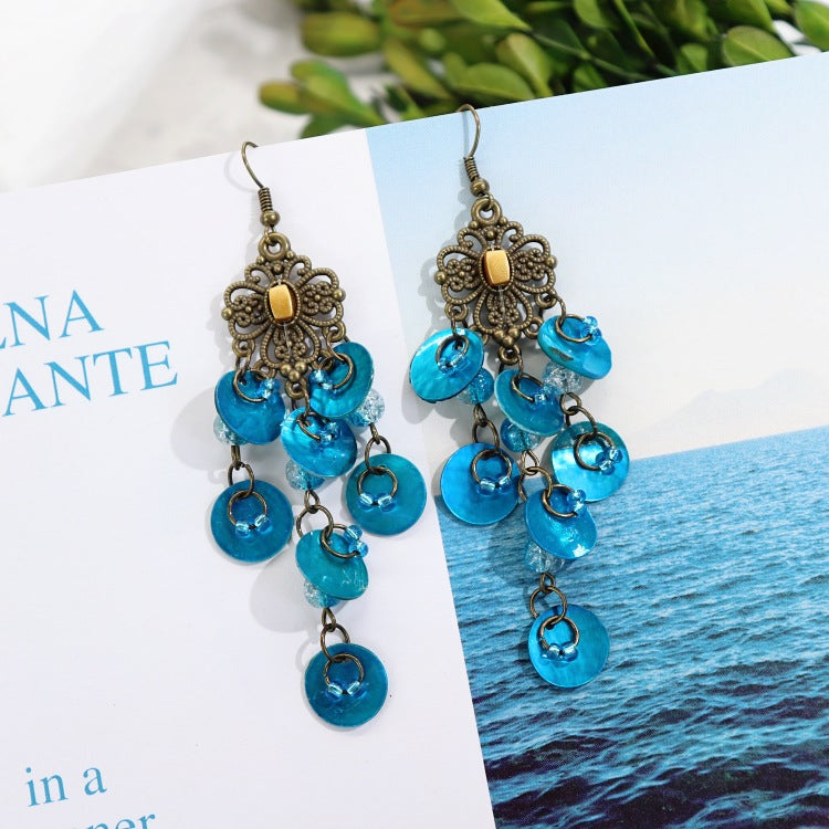Elegant mother-of-pearl earrings on model