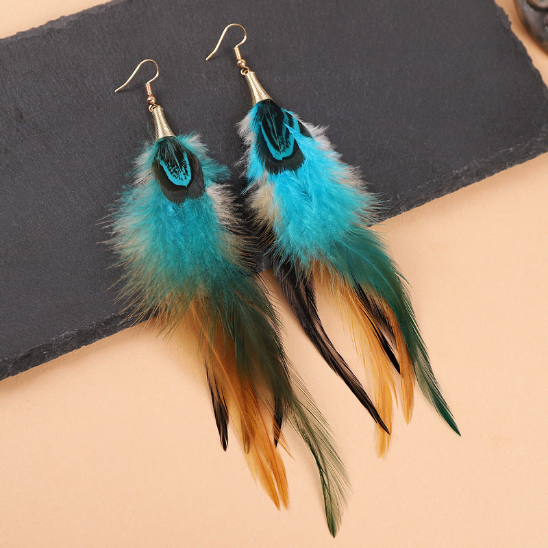 Colorful long feather earrings on a mannequin