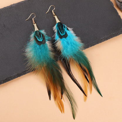Colorful long feather earrings on a mannequin